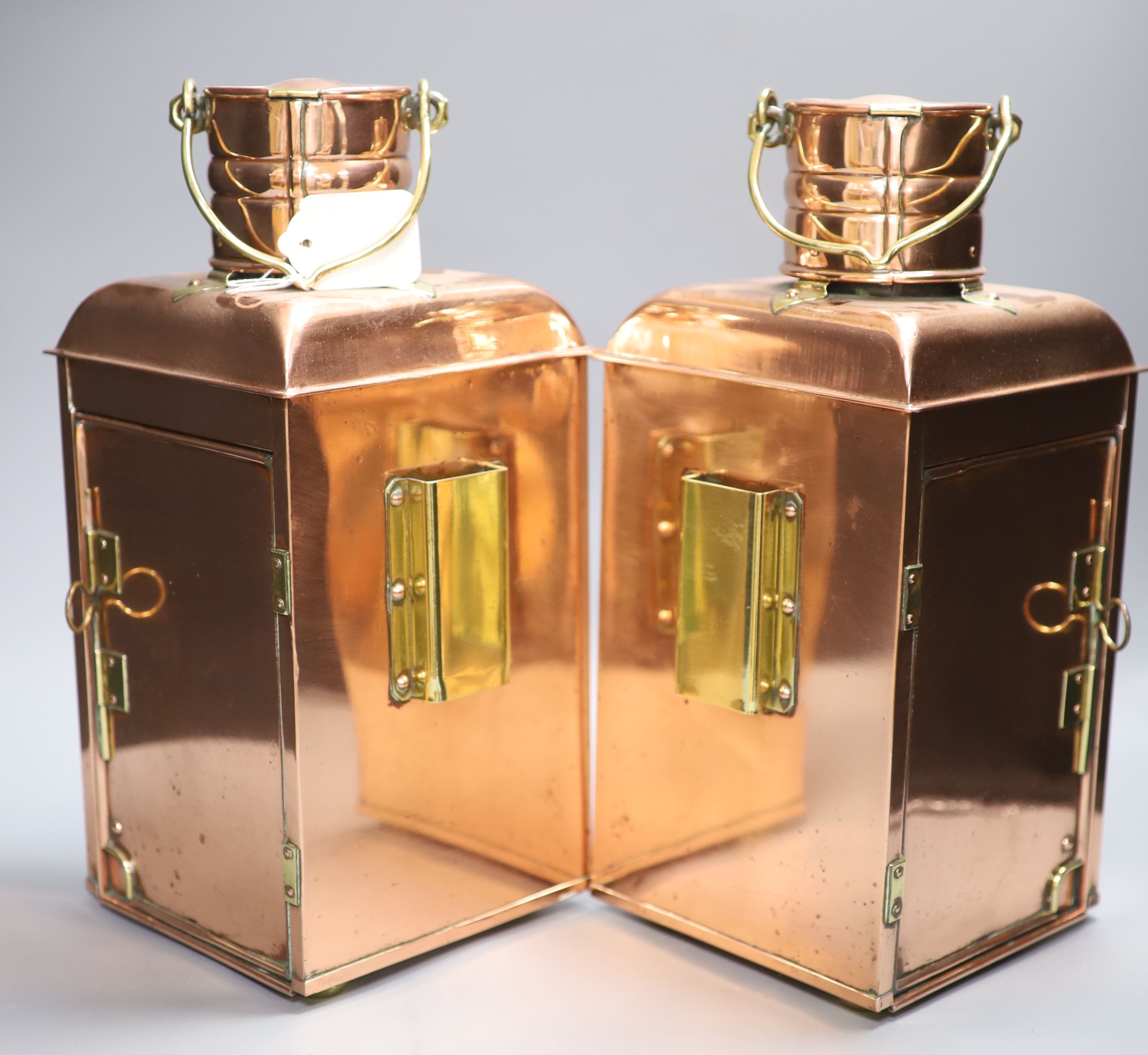 A pair of Ouvrard & Villars copper and brass ship lanterns, height 36cm